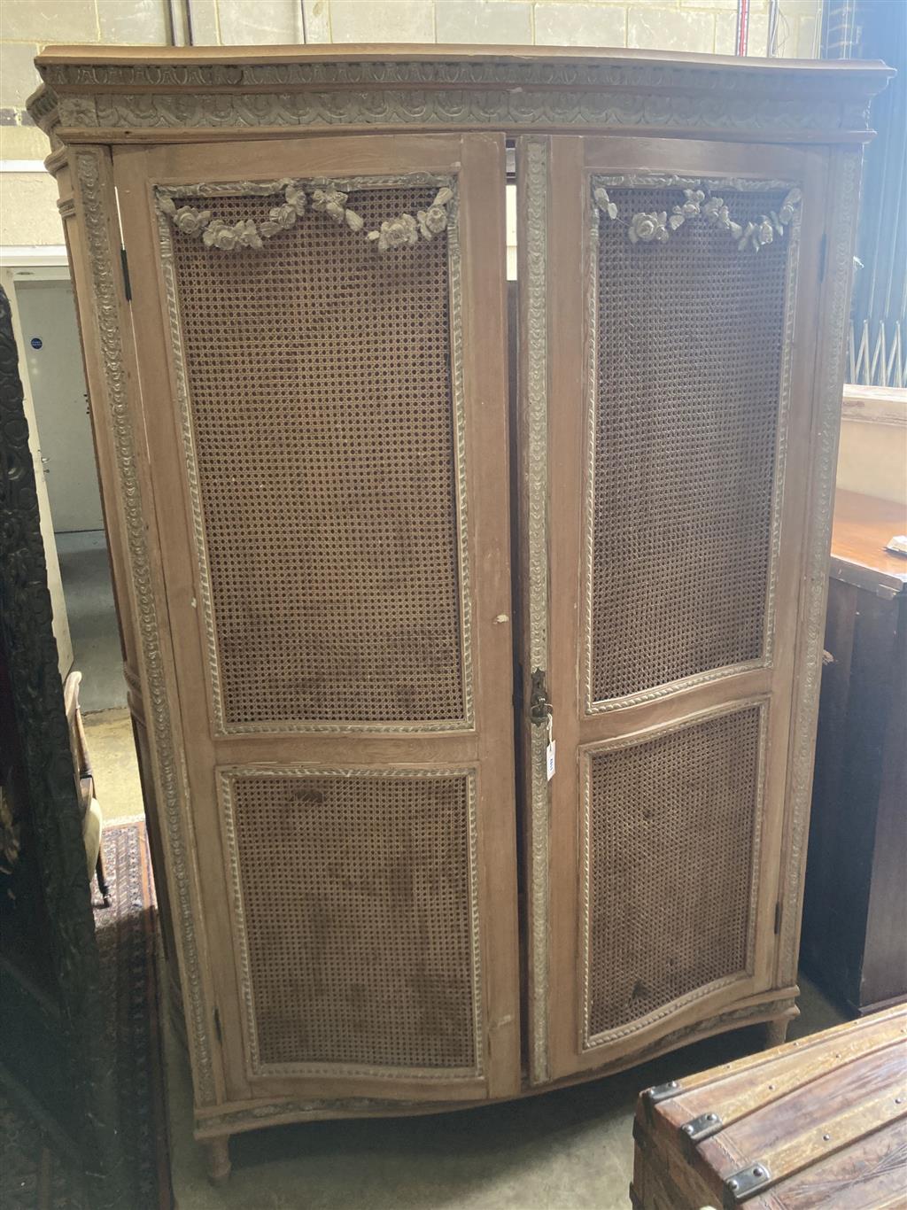 A French serpentine front caned pine armoire, width 154cm depth 60cm height 216cm